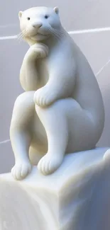 A marble otter sculpture rests elegantly on a light gray base.