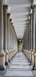 Marble pillar corridor with ornate ceiling and symmetrical design.