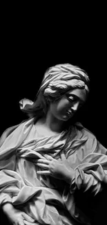 Black and white marble statue on a dark background.