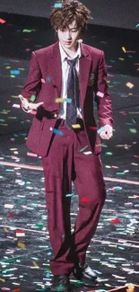 Person in maroon suit with confetti on floor.