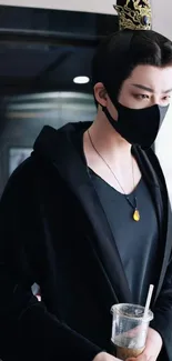 Mystical figure in black attire with a mask and necklace.