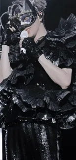 Elegant masquerade performer in black ruffled costume holding a mask.