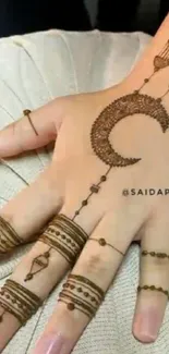 Intricate mehndi design on a hand with crescent pattern.