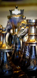 Metallic chess pieces with artistic design on a wooden board.