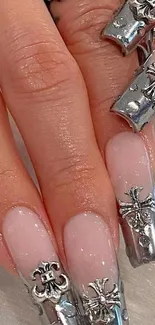 Elegant metallic nail art with intricate designs and jewels.