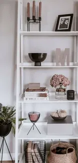 Elegant white shelf with minimalist decor and pink accents.