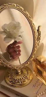 Elegant golden mirror with rose and perfume bottle.