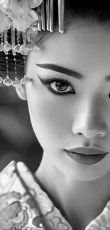 Monochrome wallpaper of a geisha with elegant traditional attire.