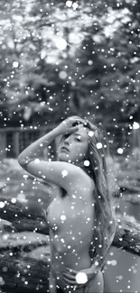 Monochrome wallpaper with woman in nature surrounded by artistic snow-like dots.