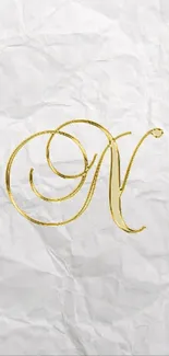 Elegant golden monogram letter 'N' on wrinkled white background for phone wallpaper.