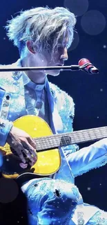 Musician in sparkling blue suit playing guitar on stage.