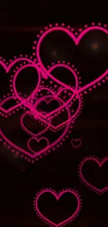 Neon pink heart shapes on a dark background.