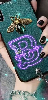 Stylish phone wallpaper with neon and golden insect design on a teal case.