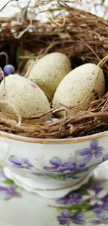 Bird's nest with eggs in a floral teacup.