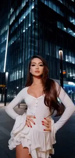 Elegant woman in white dress at night cityscape