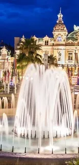 Nighttime view of a grand fountain with illuminated architecture.