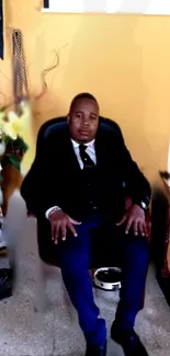 Person in a suit seated in an office chair, yellow background.