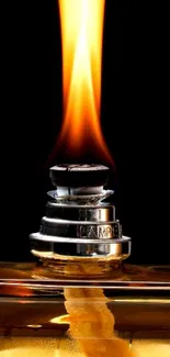 Close-up of a flame from an elegant oil lamp on dark background.