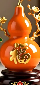 Orange gourd with golden flowers symbolizing prosperity.