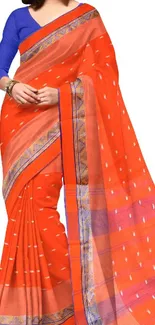 Elegant orange saree with blue blouse in traditional design.