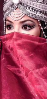 Woman with jeweled headpiece and red veil.