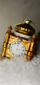 Ornate clock with gold accents on soft snow.