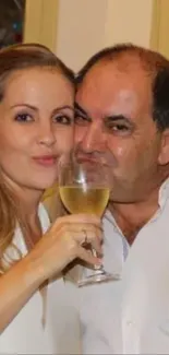 Couple toasting with wine at a celebration.