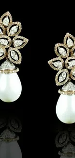 Elegant pearl and diamond earrings with black background.