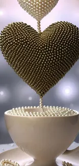 Pearl heart above a teacup in elegant design.