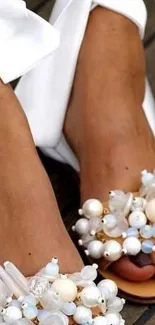 Elegant sandals with pearls and crystals, close-up view.