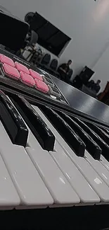 Close-up of piano keys with pink accents, creating a stylish phone wallpaper.