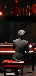 Pianist playing a grand piano on stage.