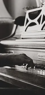 Black and white image of a person playing a piano.