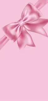 Pink ribbon bow on soft pink background wallpaper.