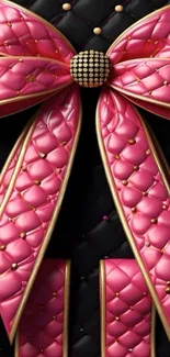 Luxurious pink bow with quilted texture and golden accents on a black background.