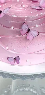 Pink cake decorated with butterflies and pearls.