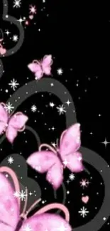 Pink butterflies on a black background wallpaper.