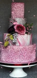 Elegant pink cake with roses and silver accents on a stand.