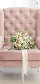 Dusty pink chair with a floral bouquet on it.