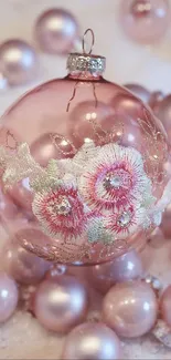 Pink Christmas ornament with floral design.