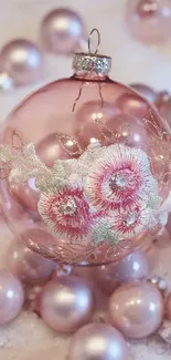 Elegant pink Christmas ornament among shiny baubles.