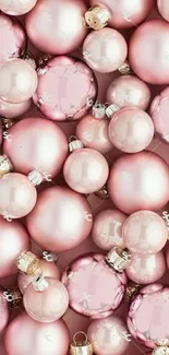 Pink Christmas ornaments mobile wallpaper with elegant festive design.