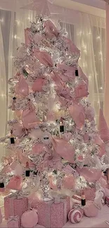 A pink Christmas tree adorned with decorations and soft lighting.