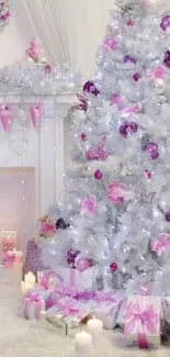 White Christmas tree with pink and purple decorations in a cozy setting.