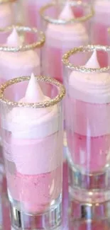 Elegant pink whipped desserts in glitter-rimmed glasses.