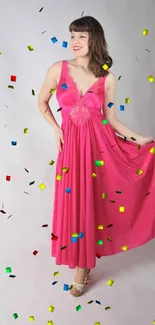 Woman in a vibrant pink dress posing elegantly.