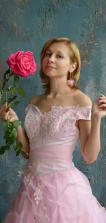 Woman in elegant pink dress holding rose.