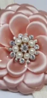 Pink satin flower with pearls on mobile wallpaper.