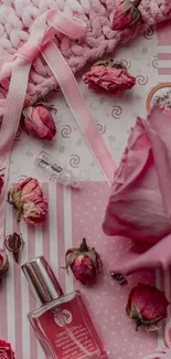 Elegant pink wallpaper with roses and perfume bottle.