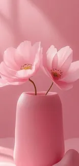 Delicate pink flowers in a vase against a pink background.